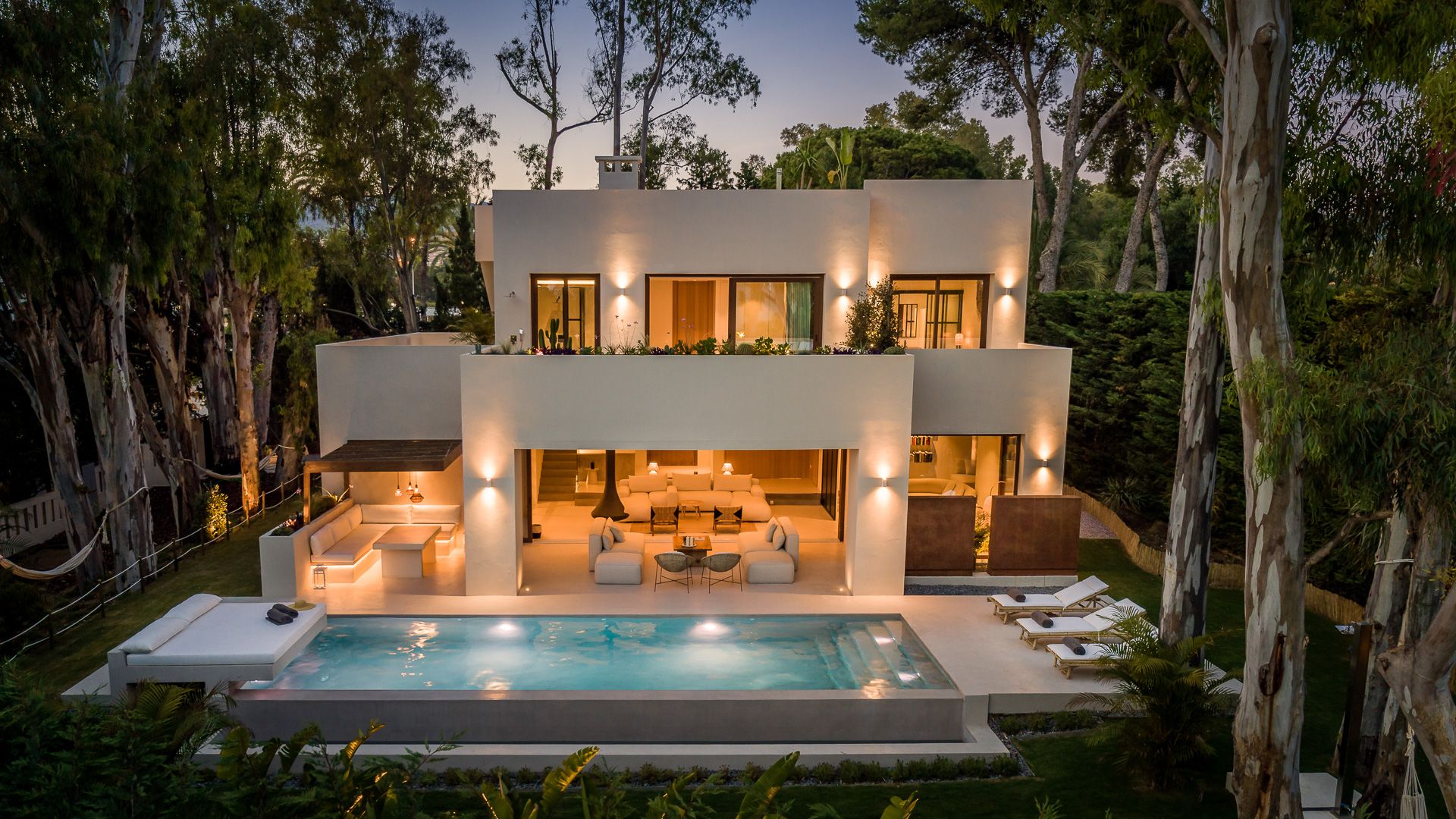 Villa Enoha Marbella - Vue extérieure de nuit de la grande villa illuminée avec piscine